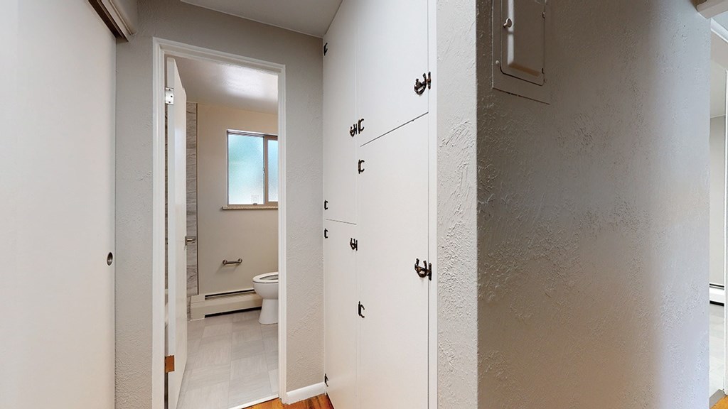 A white bathroom with a toilet and sink.