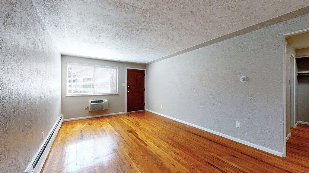 A room with wooden floors and white walls.