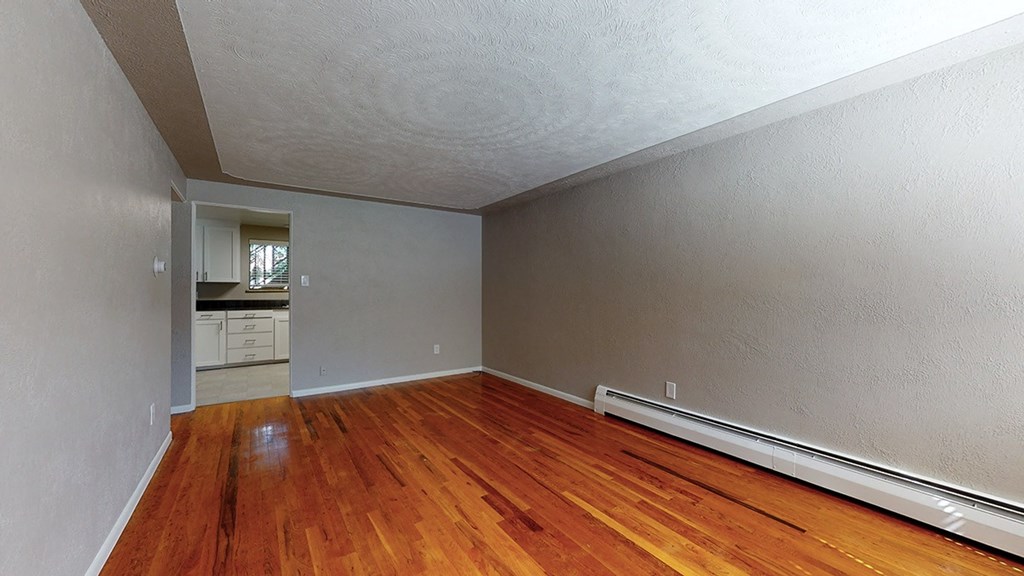 A room with wooden floors and white walls.