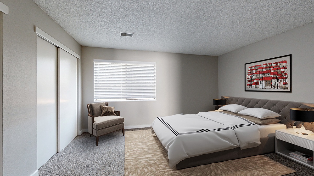 A bedroom with a large bed and a chair by the window.