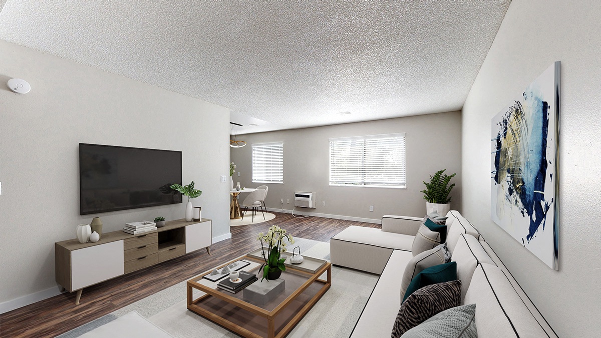 A living room with a flat screen TV and a coffee table.
