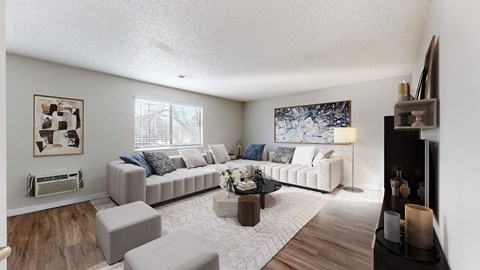 A living room with a grey couch and a coffee table.