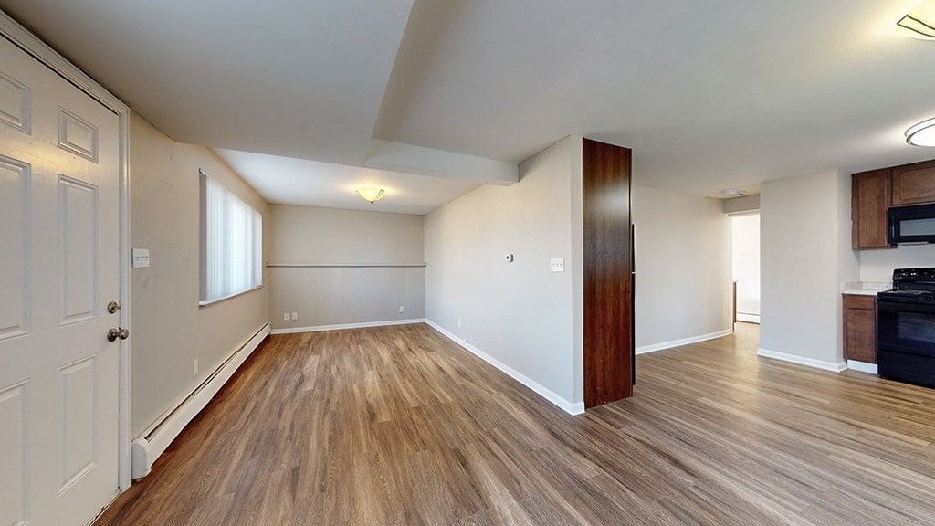 A room with wooden floors and white walls.