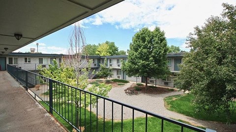 A view of a courtyard from a covered walkway.