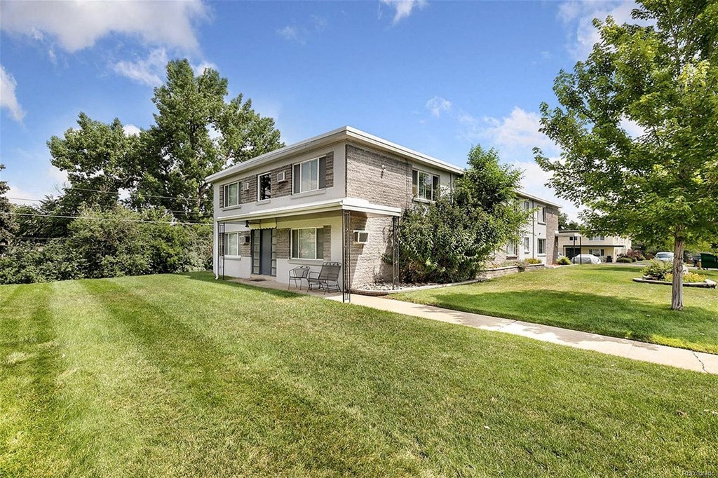 A house with a well-maintained lawn in front.