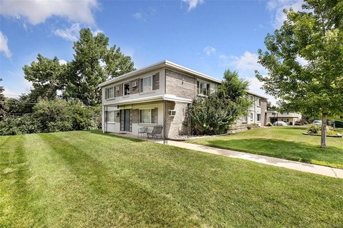 A house with a well-maintained lawn in front.