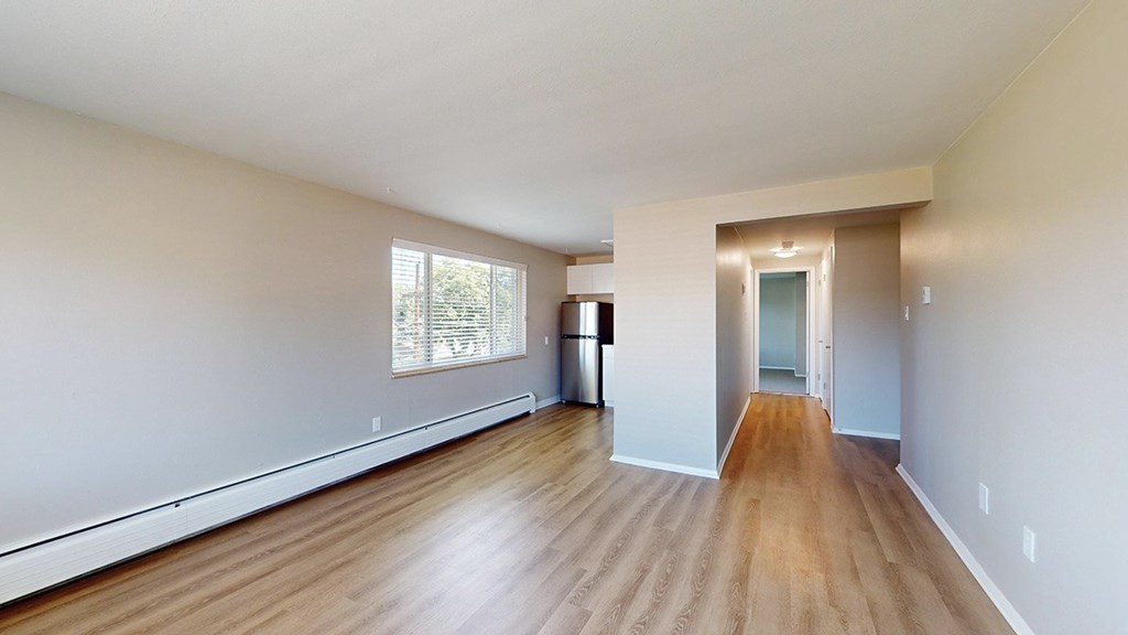A room with wooden floors and white walls.