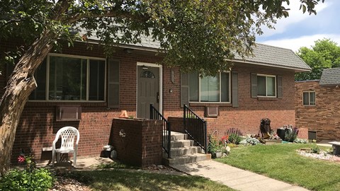 A house with a brick facade and a white door.