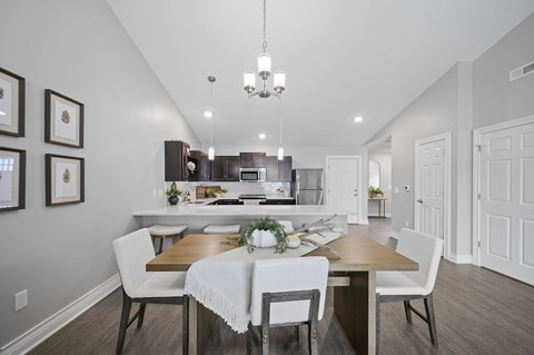 A dining room with a table set for four.