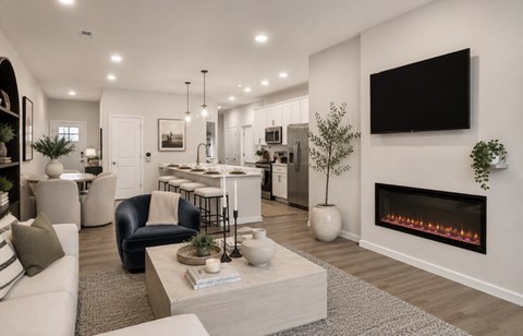 A modern living room with a fireplace and a flat screen TV mounted on the wall.
