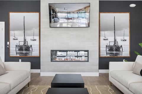 A living room with a fireplace and a large painting above it.
