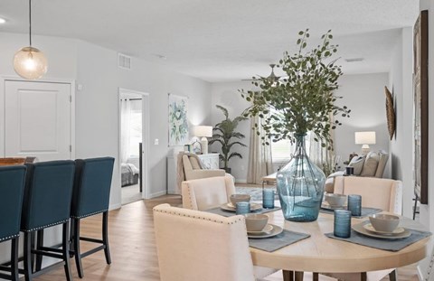 A dining room with a table set for six.