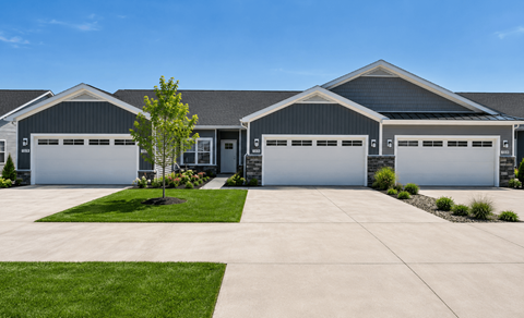 A large house with two garages and a driveway.
