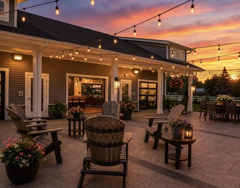 A cozy outdoor patio with wooden furniture and string lights.