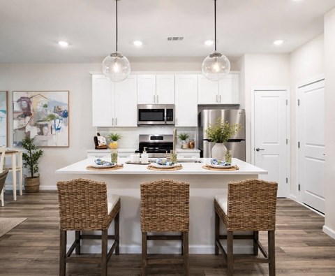 A modern dining room with a white table and chairs.