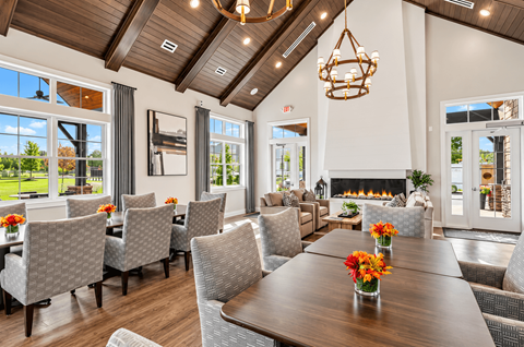 A dining room with a wooden table and chairs.