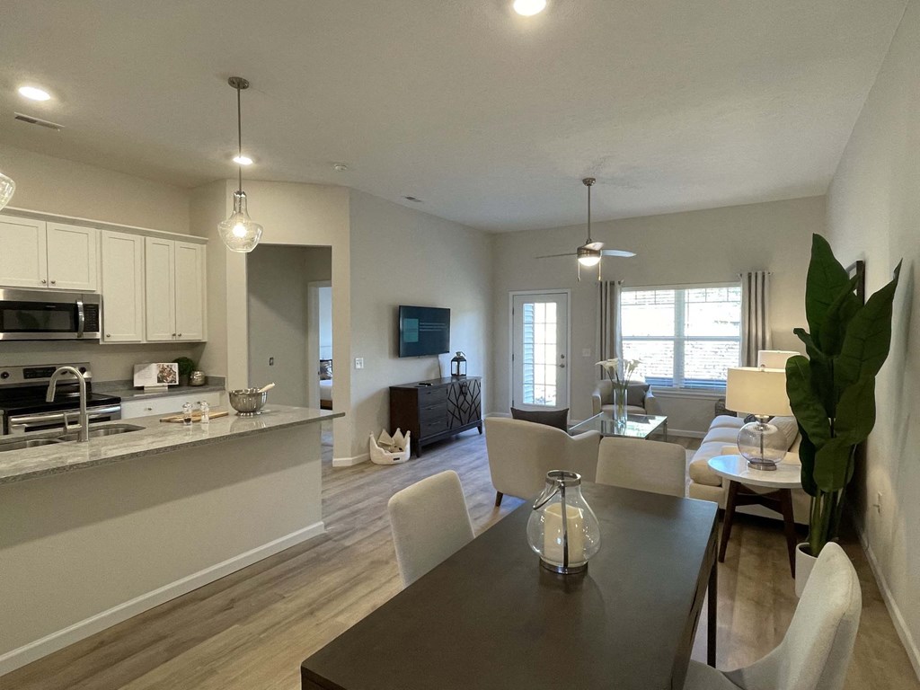 A modern kitchen with a dining table and chairs.