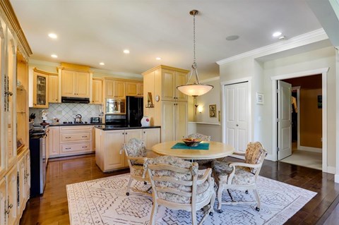 A kitchen with a table and chairs in the middle of the room.