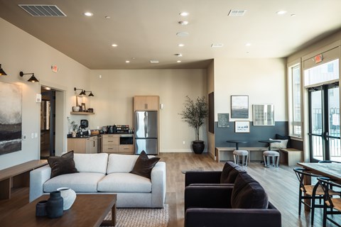 A modern living room with a white sofa and a wooden coffee table.