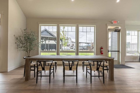A dining room with a table and chairs and a view of the backyard at Marcola Apartment Homes, Oregon