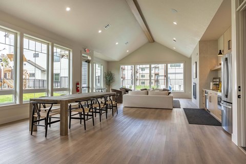 A large open living room with a dining table and chairs.
