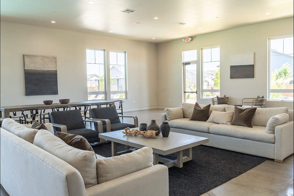 A living room with a white couch, black chairs, and a coffee table. A living room with a white couch, black chairs, and a coffee table at Northplace Apartment Homes, Salem, OR
