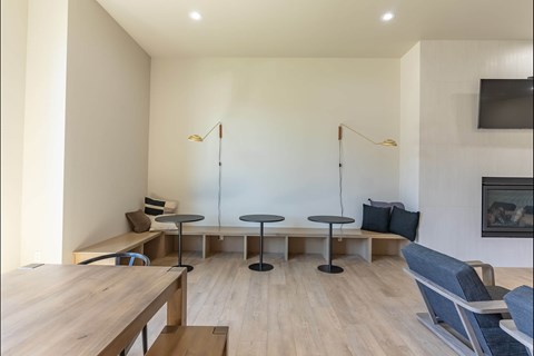 A modern living room with a wooden table and blue chairs at Northplace Apartment Homes, Salem, OR, 97305