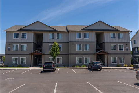 A large building with a parking lot in front of it at Northplace Apartment Homes, Oregon