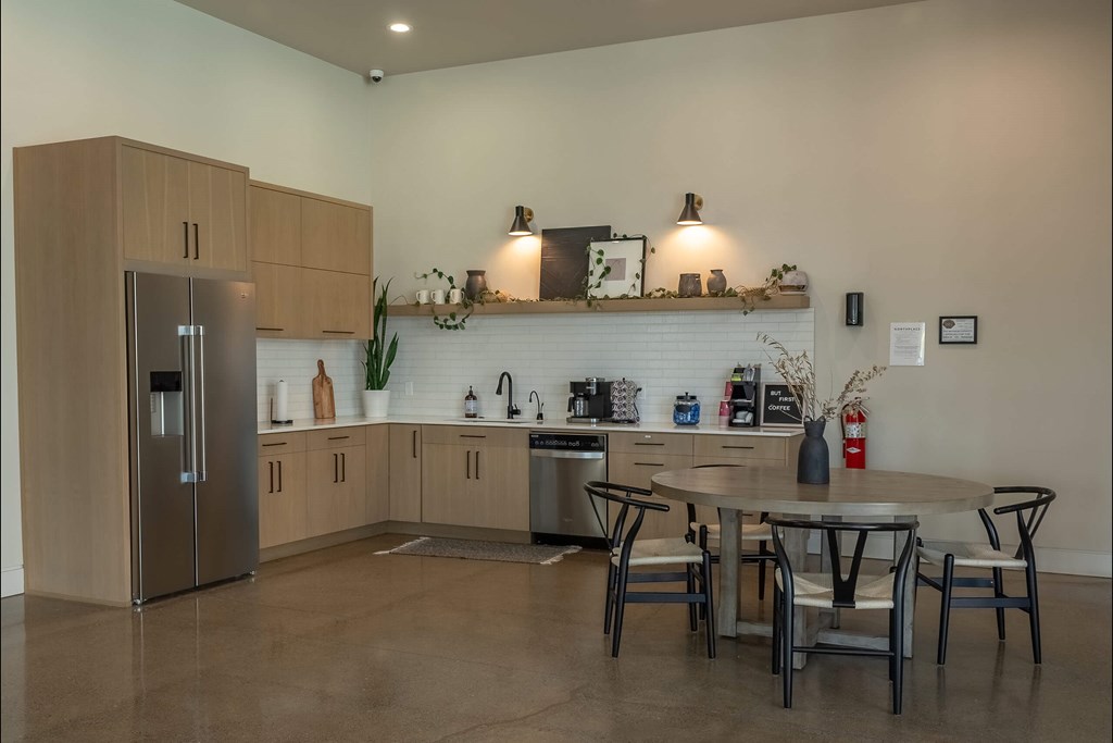 A modern kitchen with a refrigerator, sink, and dining table. A modern kitchen with a refrigerator, sink, and dining table at Northplace Apartment Homes, Salem