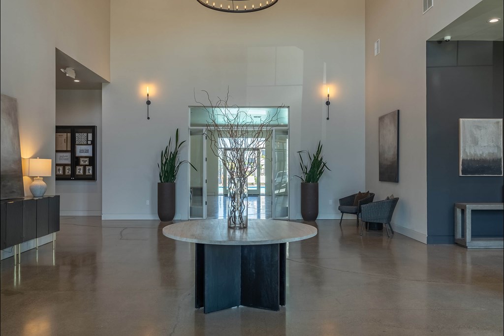 A large, round table sits in the middle of a spacious room with a glass wall behind it. A large, round table sits in the middle of a spacious room with a glass wall behind it at Northplace Apartment Homes, Salem, OR