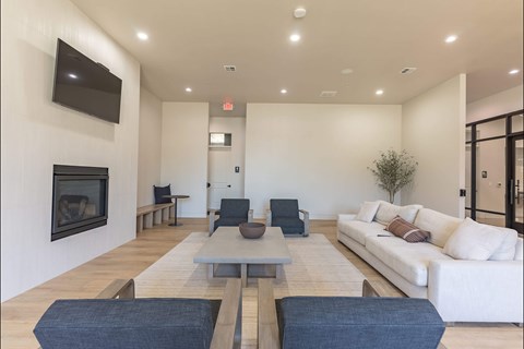 A modern living room with a fireplace and a white couch at Northplace Apartment Homes, Salem