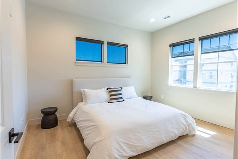 A bedroom with a large bed and two windows at Westgate Apartment Homes, Pendleton, 97801