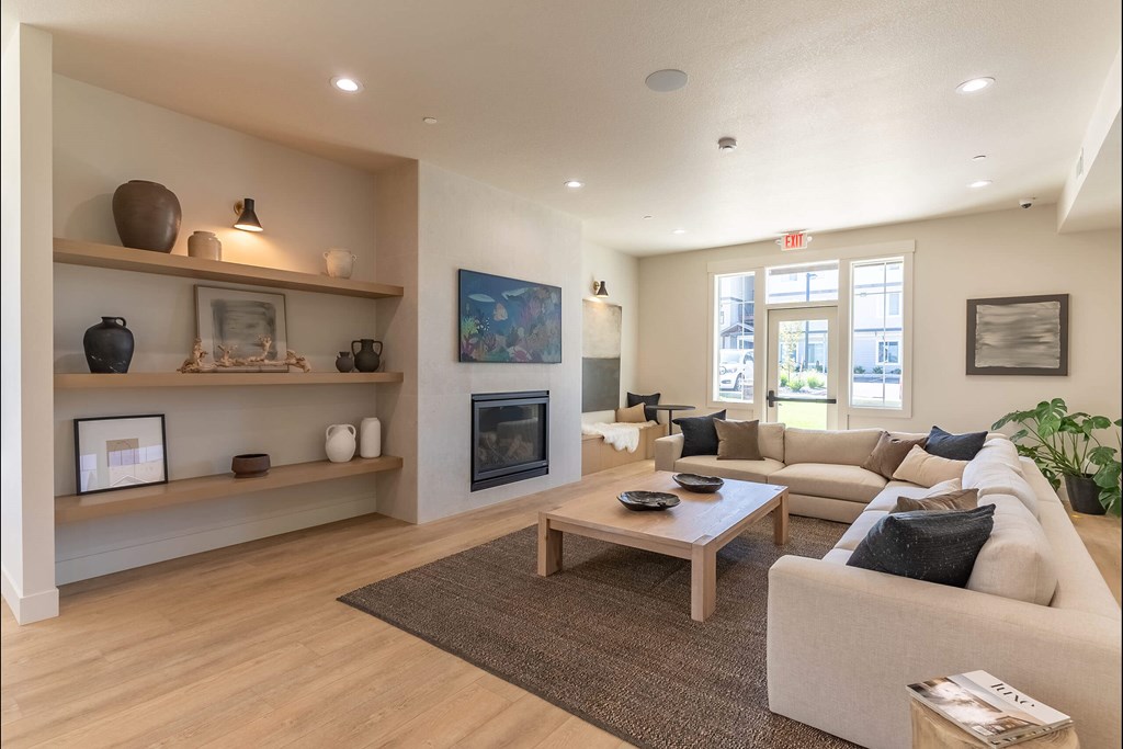 A living room with a fireplace and a couch. A living room with a fireplace and a couch at Cascade Place Apartment Homes, Oregon