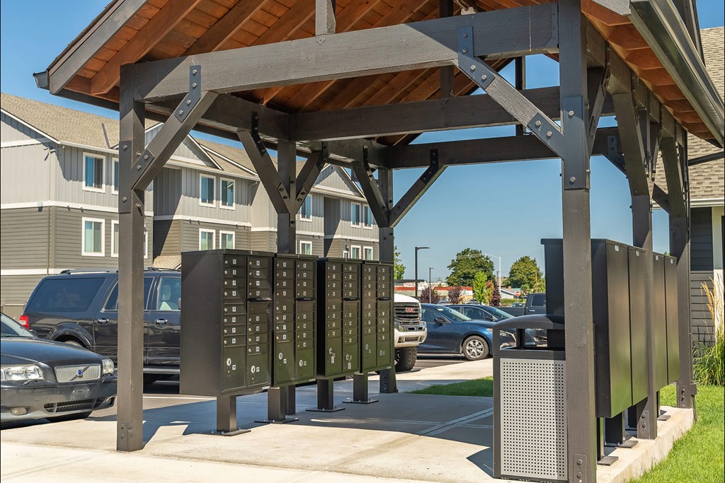 A wooden structure with a metal signboard underneath it at Cascade Place Apartment Homes, Molalla, OR, 97038