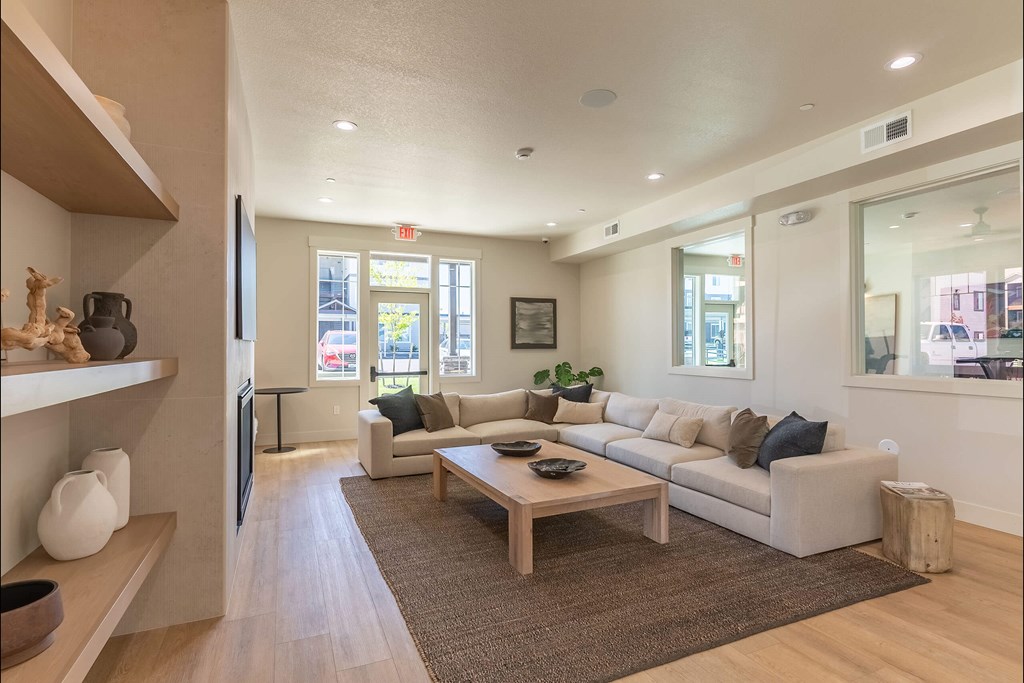 A living room with a couch, coffee table, and a television at Cascade Place Apartment Homes, Oregon, 97038