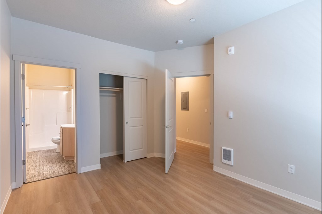 A room with a wooden floor and white walls at Cascade Place Apartment Homes, Oregon, 97038