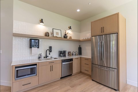 A kitchen with wooden cabinets and stainless steel appliances.