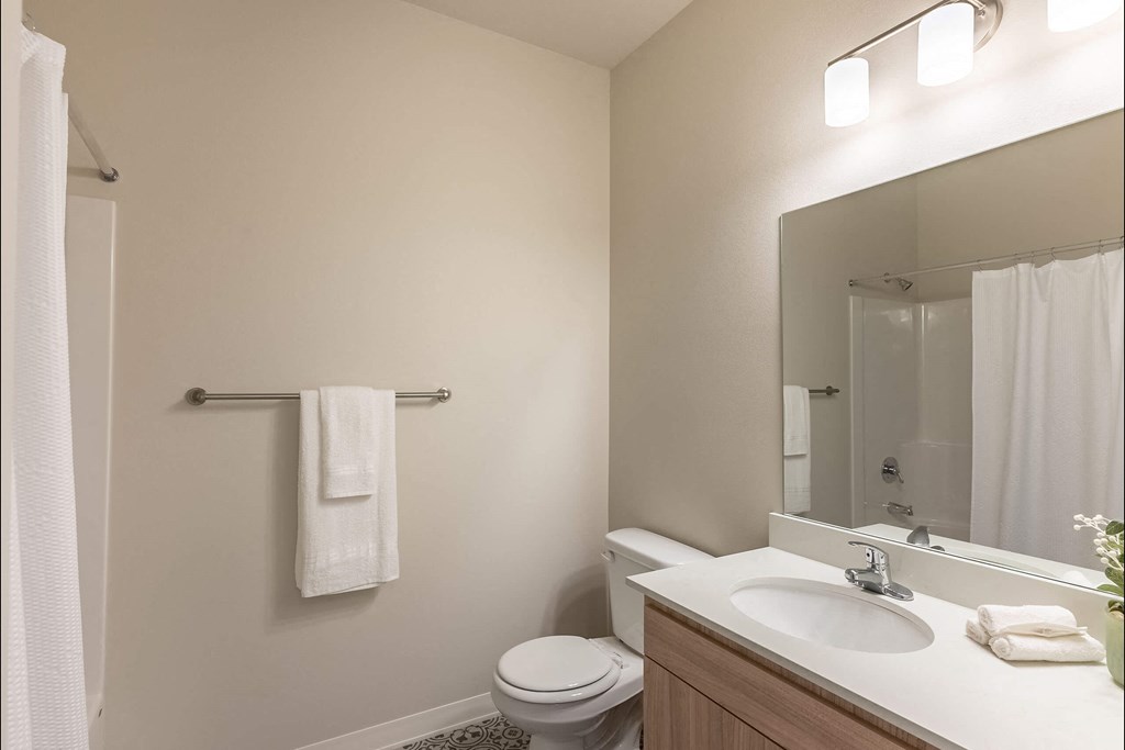 A white towel hangs on a towel rack in a bathroom at Cascade Place Apartment Homes, Molalla, Oregon