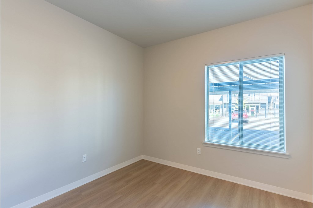 Empty room with a window overlooking a parking lot at Cascade Place Apartment Homes, Oregon, 97038