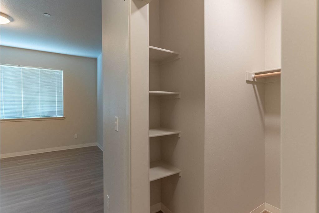 A white closet with shelves and a window at Cascade Place Apartment Homes, Oregon