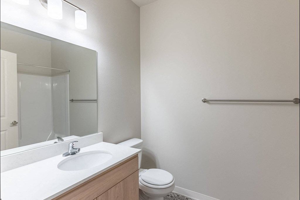 A white sink with a mirror above it in a bathroom at Cascade Place Apartment Homes, Molalla, OR, 97038