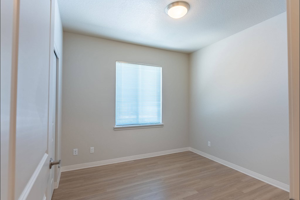 A room with a window and wooden flooring at Cascade Place Apartment Homes, Molalla, OR