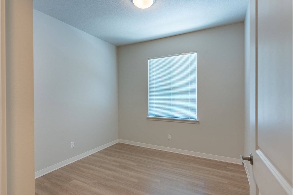 A room with a window and wooden flooring at Cascade Place Apartment Homes, Oregon, 97038