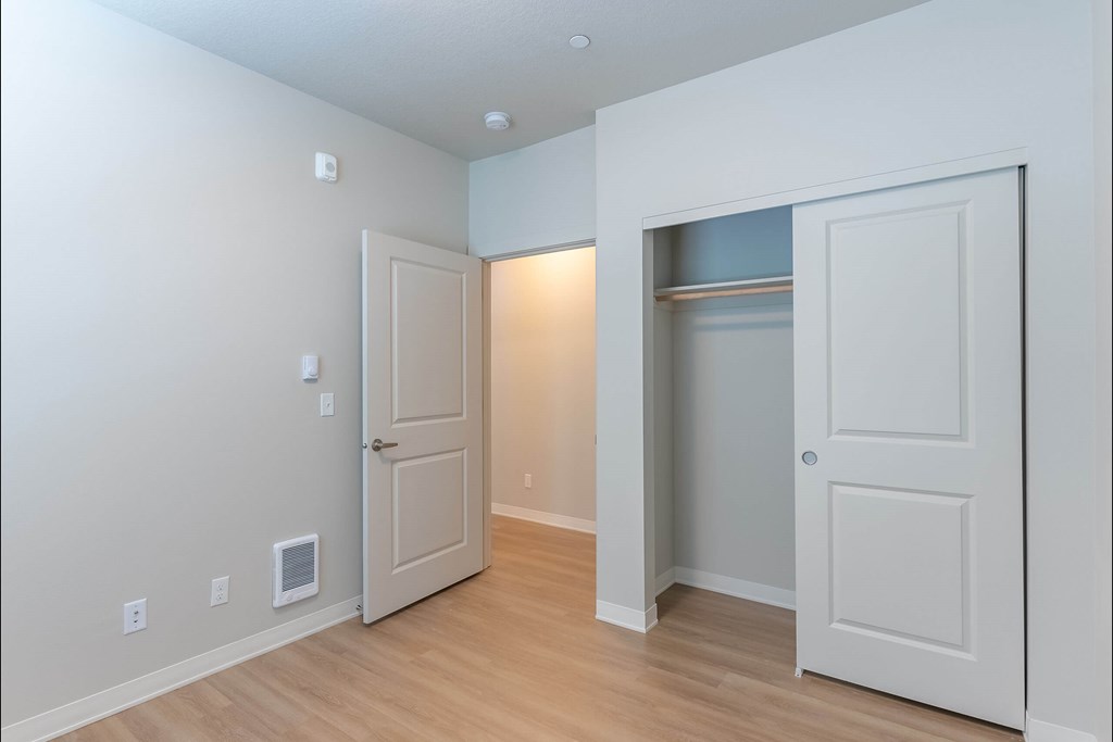 A room with a white door and a white wall with switches at Cascade Place Apartment Homes, Molalla, OR