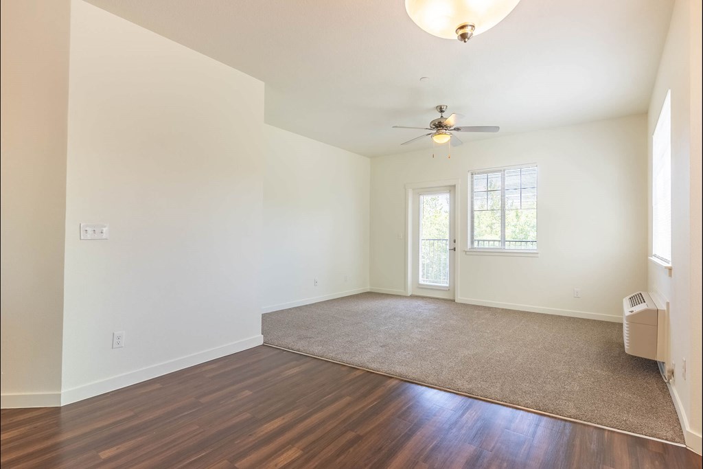 A room with a ceiling fan and a rug on the floor at Riverplace Apartment Homes, Oregon, 97351
