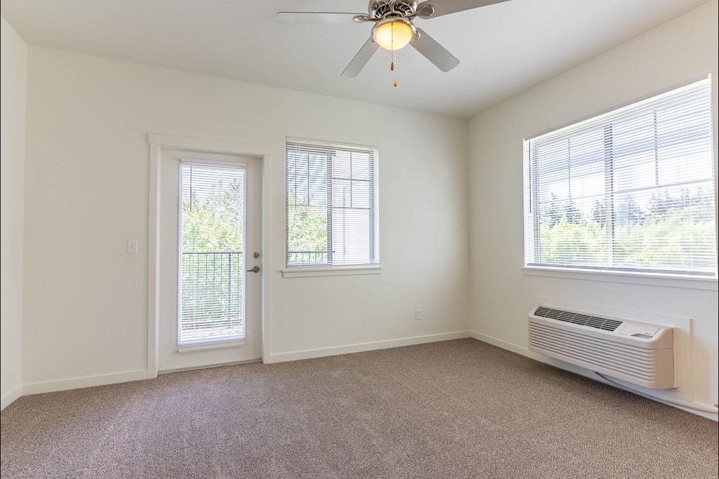 A room with a ceiling fan and a window with blinds at Riverplace Apartment Homes, Independence, OR