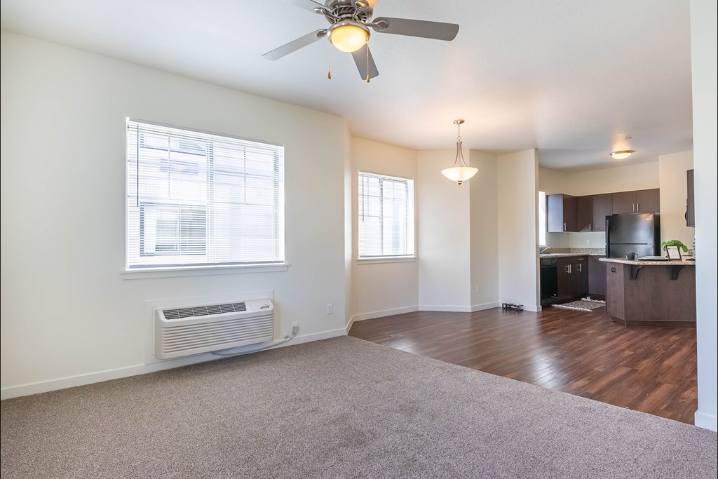 A room with a ceiling fan and a window with blinds at Riverplace Apartment Homes, Independence, OR, 97351