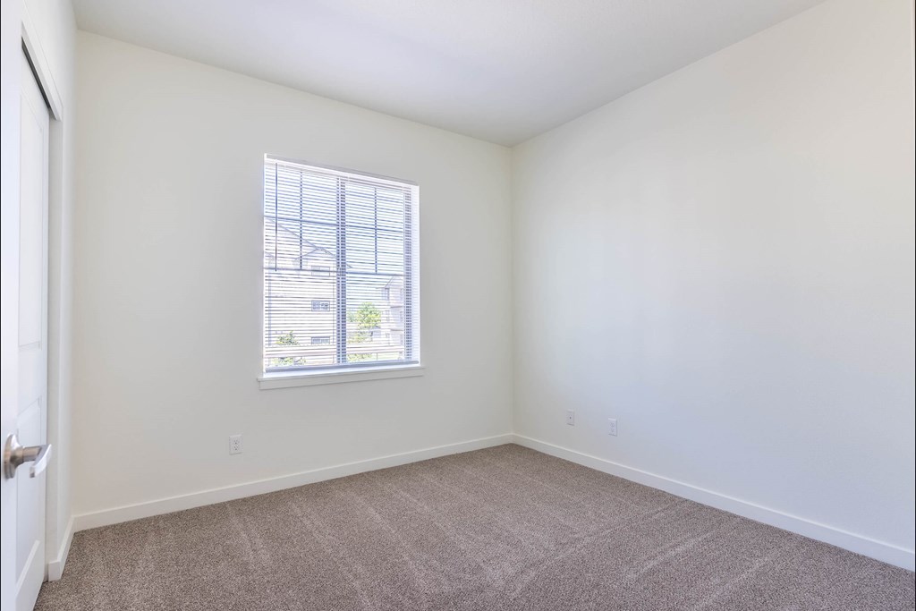 A room with a window and carpeted floor at Riverplace Apartment Homes, Independence, Oregon
