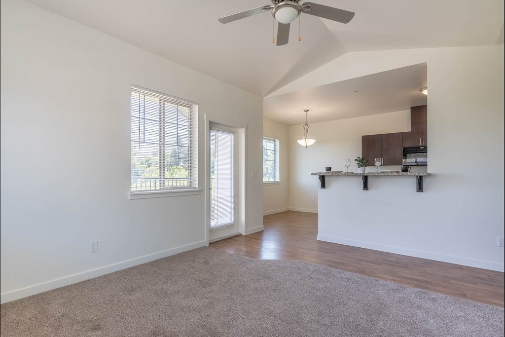 A spacious room with a ceiling fan and a window at Riverplace Apartment Homes, Oregon, 97351