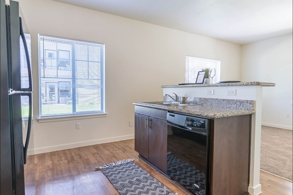 A kitchen with a refrigerator, oven, and microwave at Riverplace Apartment Homes, Independence, Oregon